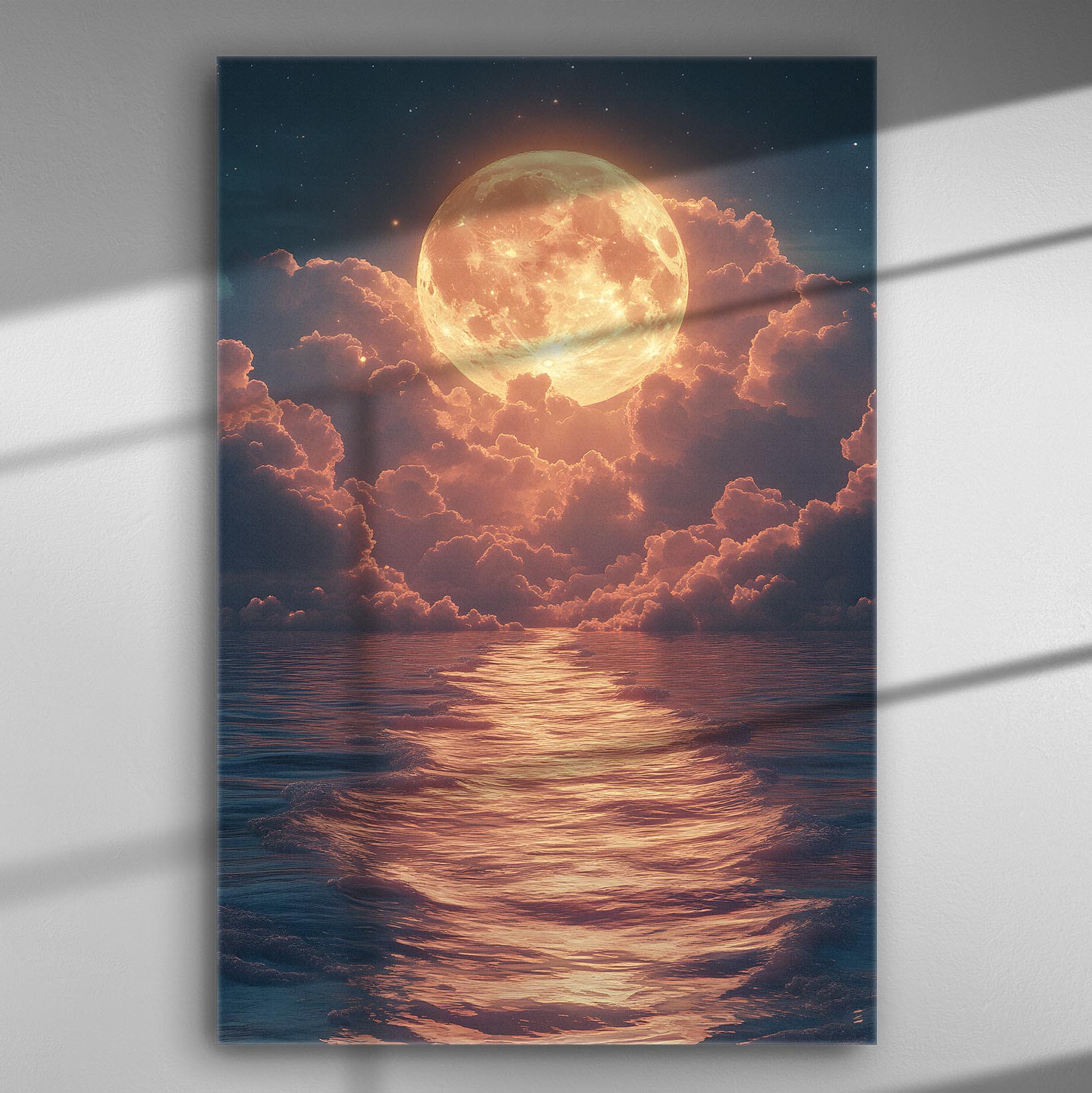 Full moon rising amidst clouds with sunset light over the ocean.