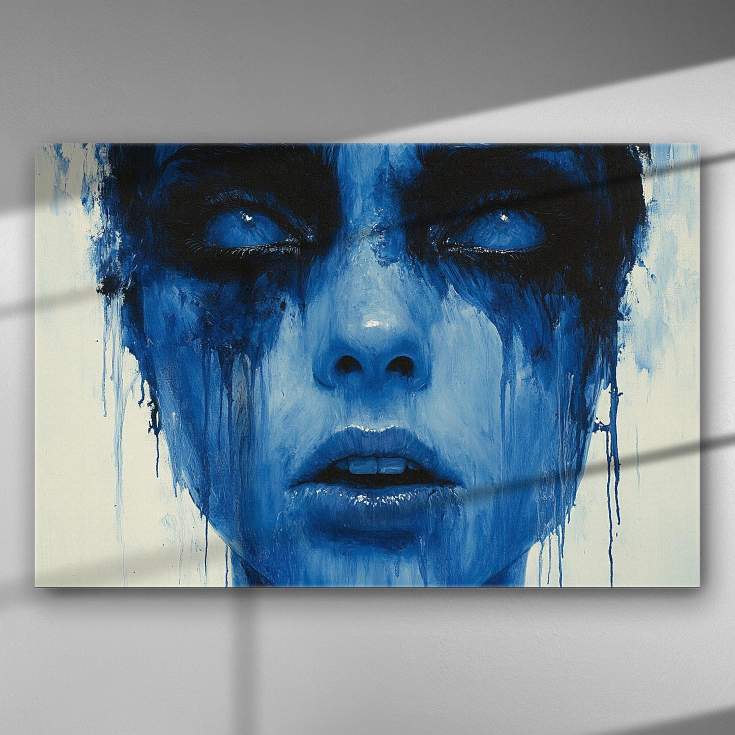 Abstract painting of a face with blue and black tones creating a melancholy effect.