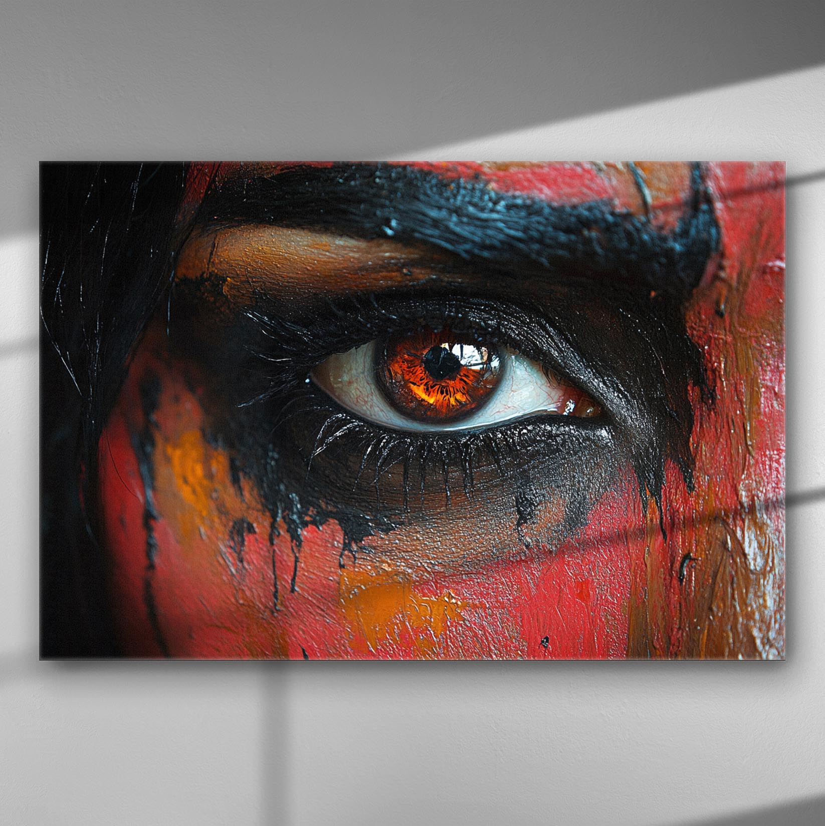 A close-up of a painted eye with vibrant orange and black colors on canvas