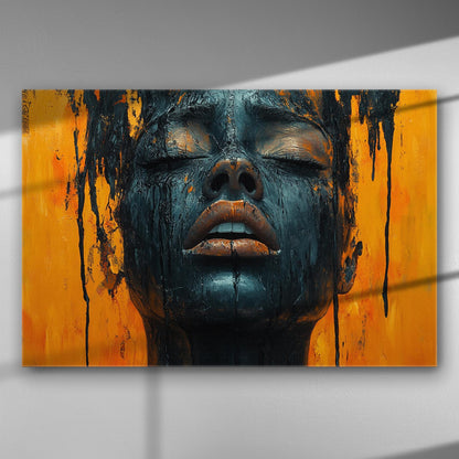 A canvas print of a face with black paint on an orange background, showcasing emotional expression and artistic contrast.