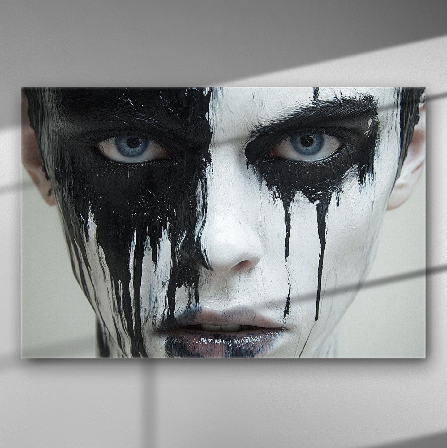 Close-up portrait of a face with dramatic black paint dripping around the eyes, contrasting against pale skin.