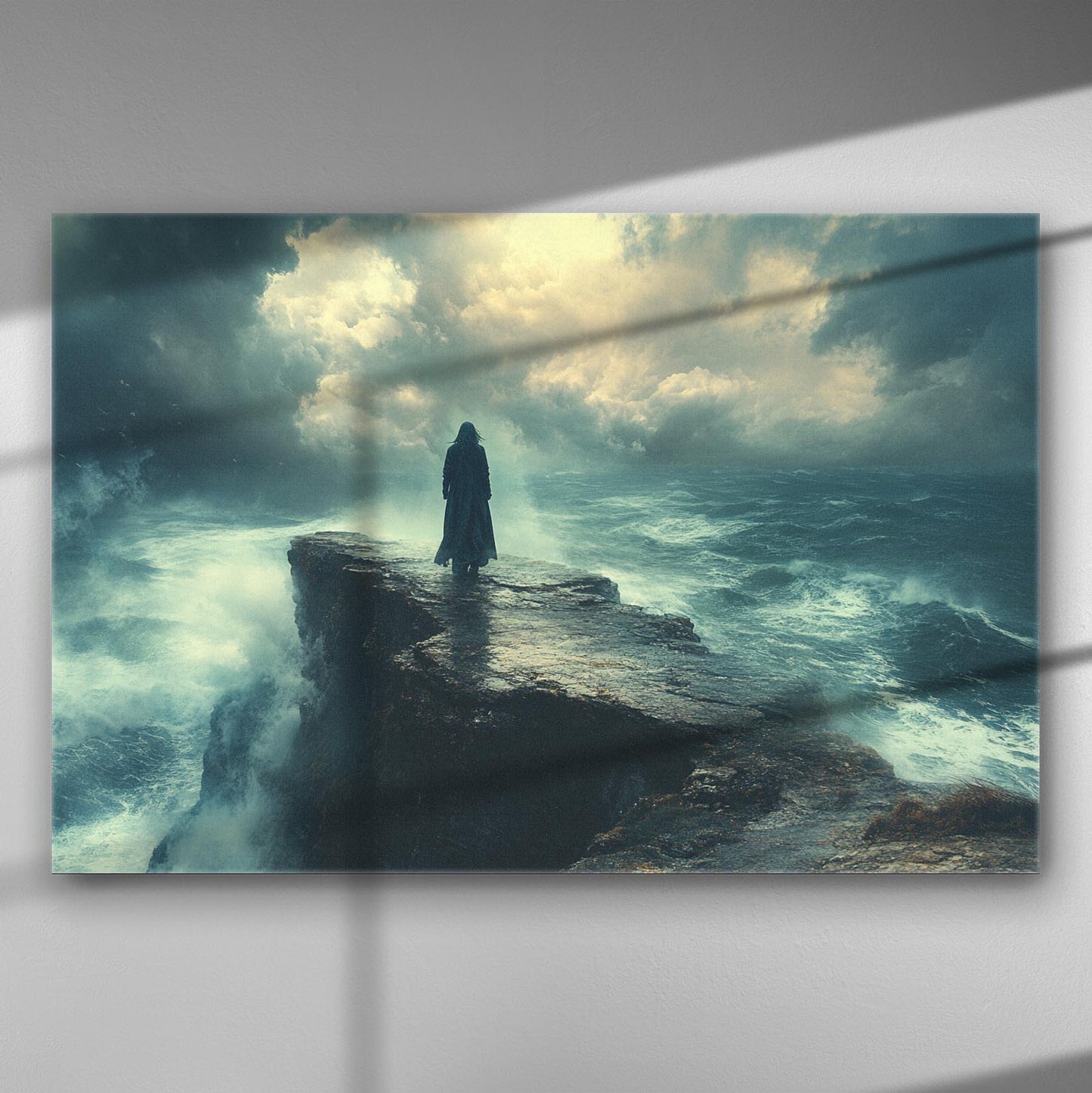 A solitary figure stands on the edge of a cliff overlooking a stormy sea with dramatic clouds above.