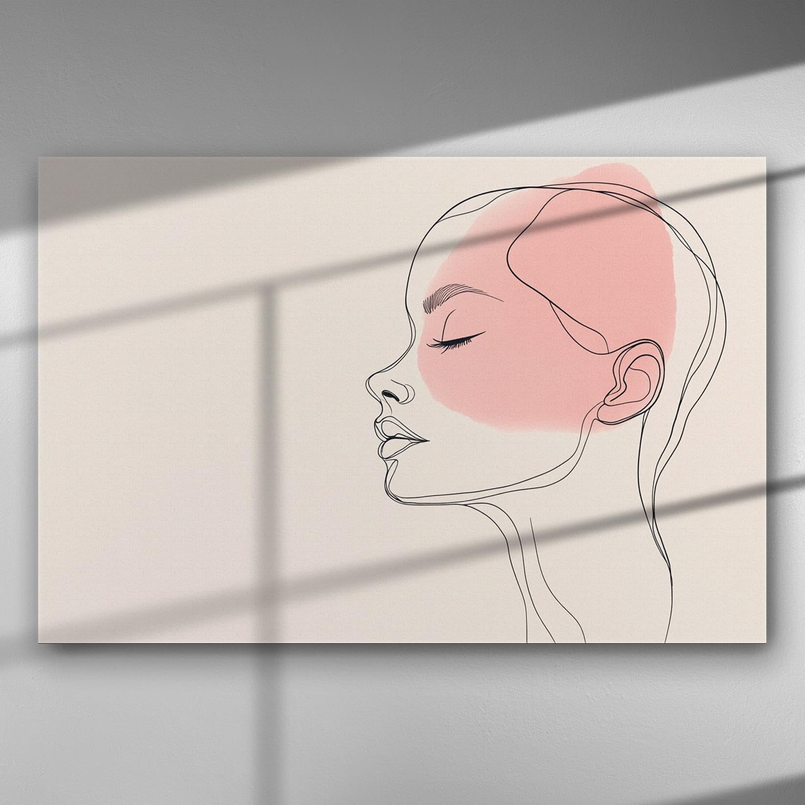 Abstract line art of a woman's profile with a pink accent on a canvas print.