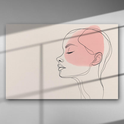 Abstract line art of a woman's profile with a pink accent on a canvas print.