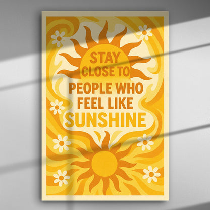 Canvas print with the text: 'Stay close to people who feel like sunshine' with yellow and orange sun and flowers.