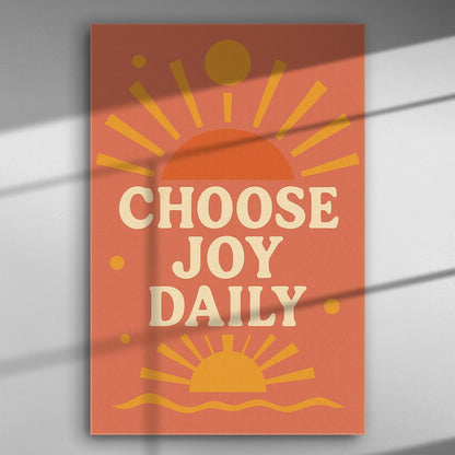 Canvas print with the text 'Choose Joy Daily' in orange and yellow, featuring sunburst graphics.