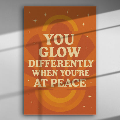 Canvas print with quote 'You glow differently when you're at peace' in orange and beige tones.