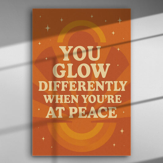 Canvas print with quote 'You glow differently when you're at peace' in orange and beige tones.