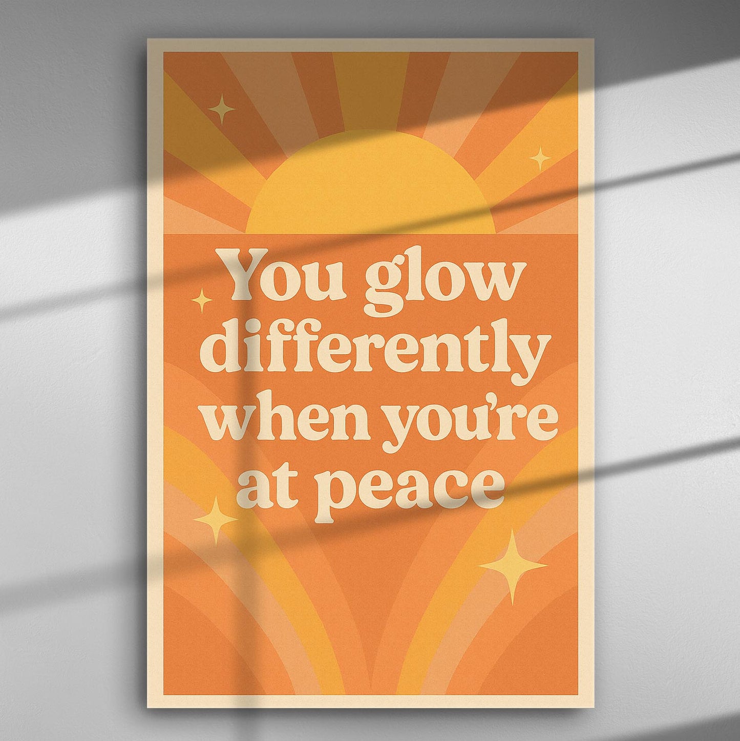 Inspirational canvas print with warm orange colors and text 'You glow differently when you're at peace'.