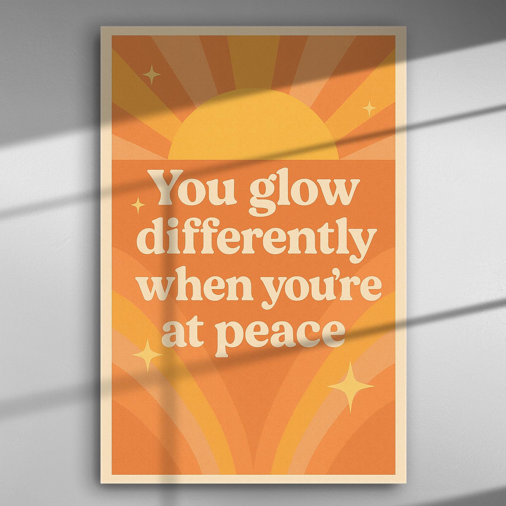 Inspirational canvas print with warm orange colors and text 'You glow differently when you're at peace'.