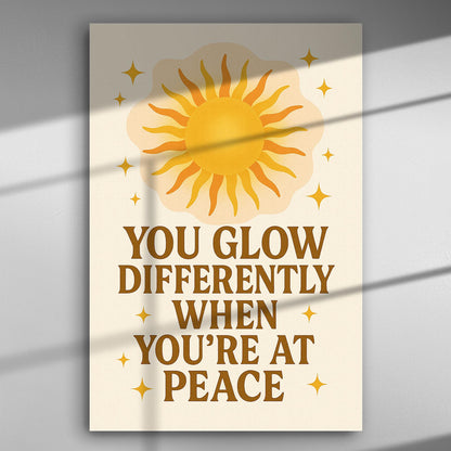 Canvas print with sun illustration and the text 'You glow differently when you're at peace'.