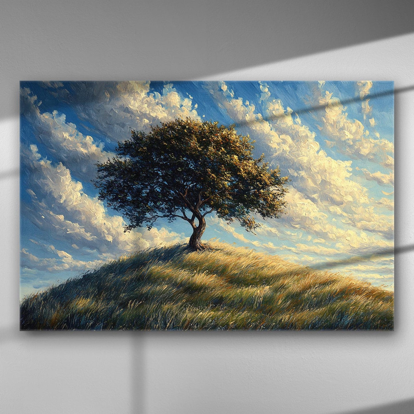 Canvas print of a solitary tree on a hill under a blue sky with clouds.