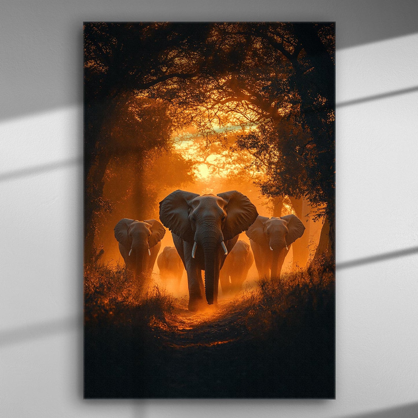 A group of elephants walking through a forest with an orange sunset in the background.