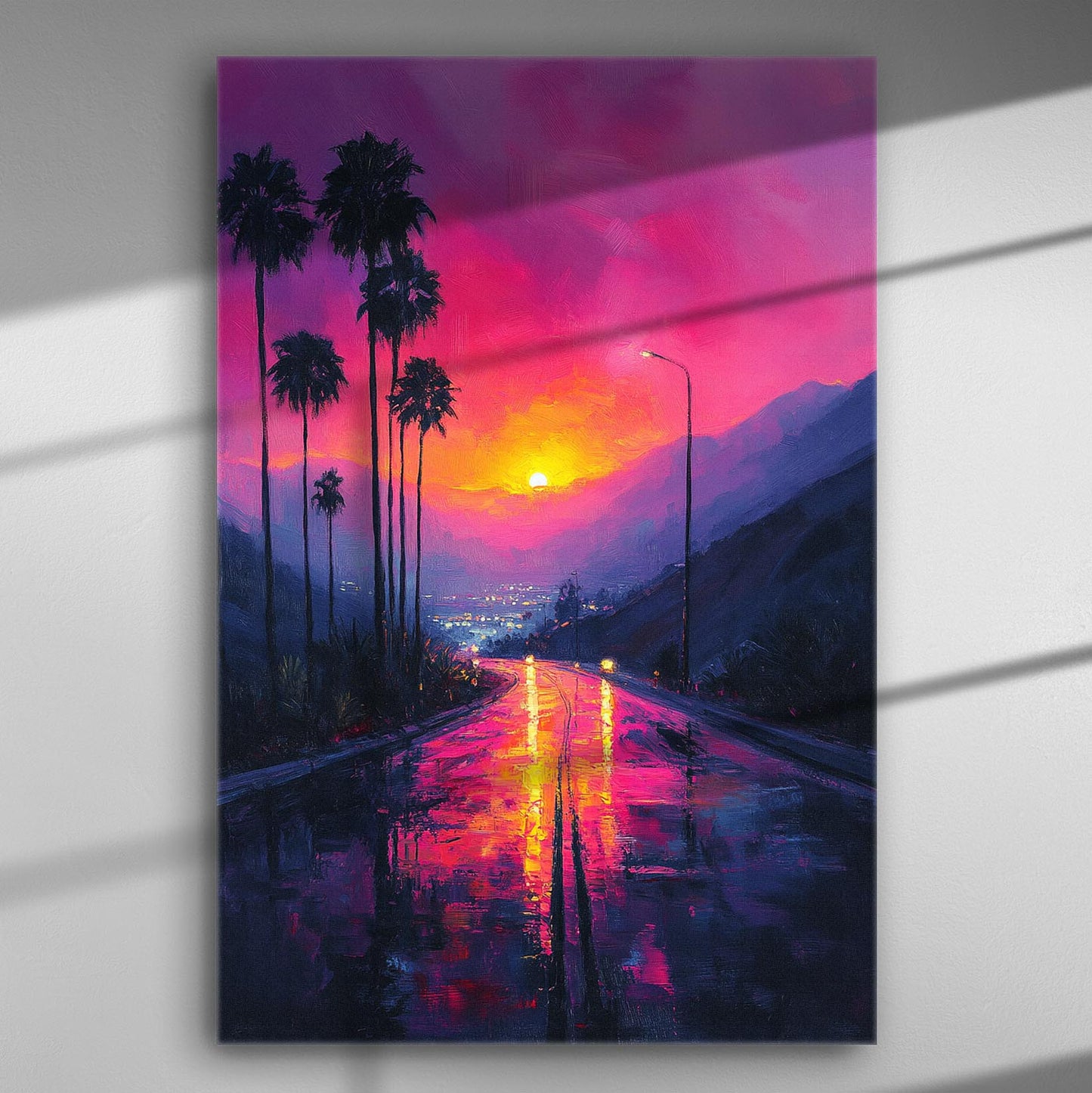 Vibrant sunset over a road with palm trees, colorful sky reflected on the wet street.