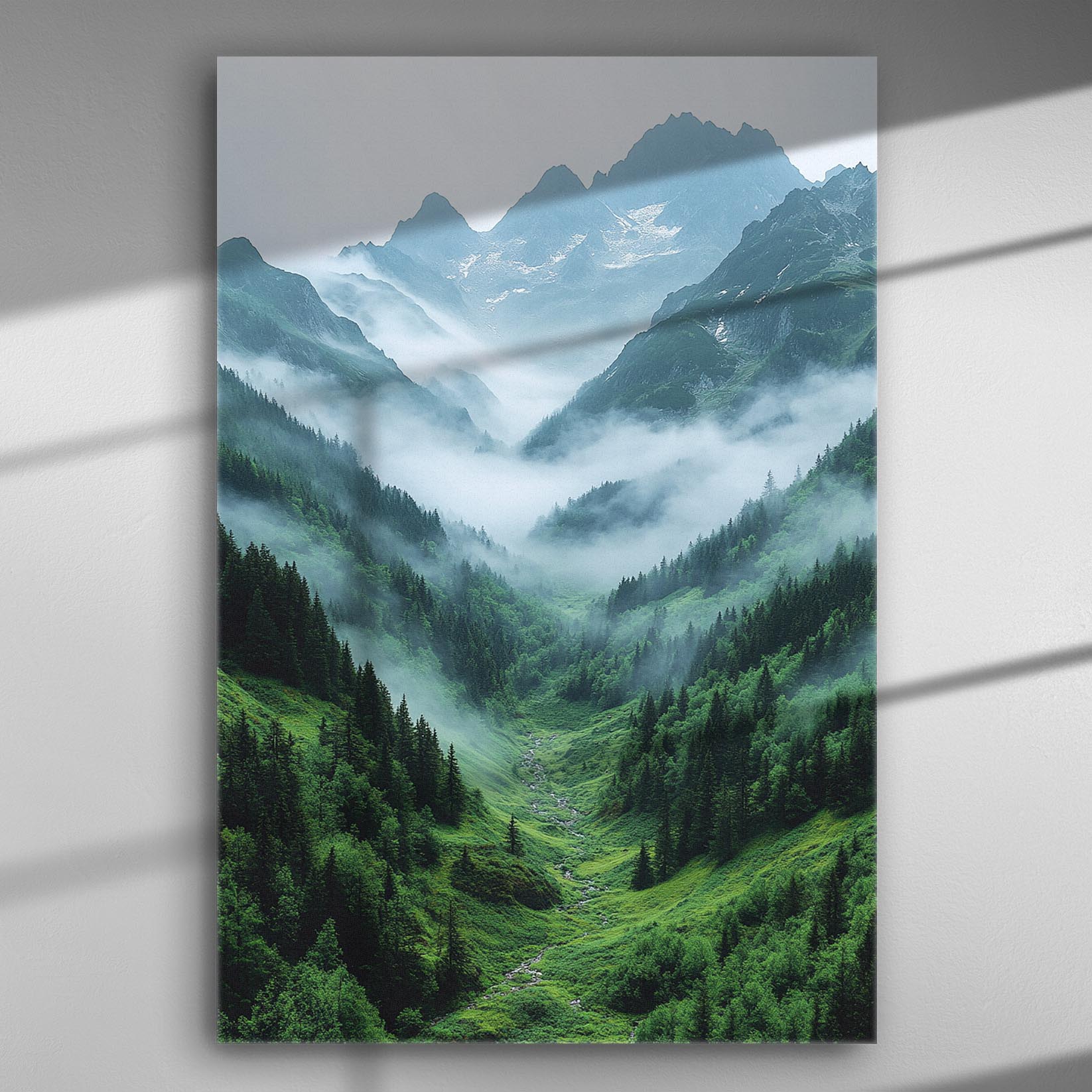 Mountain landscape with mist covering valleys and peaks, green forests below.