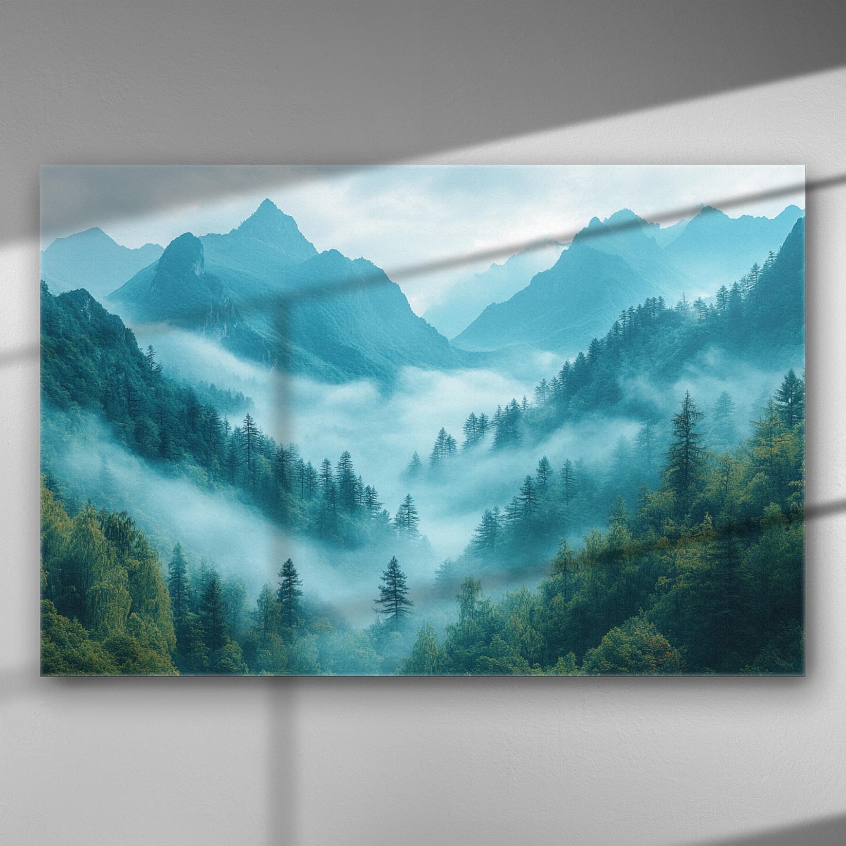 A serene mountain landscape shrouded in mist, with blue and green tones on a canvas print.