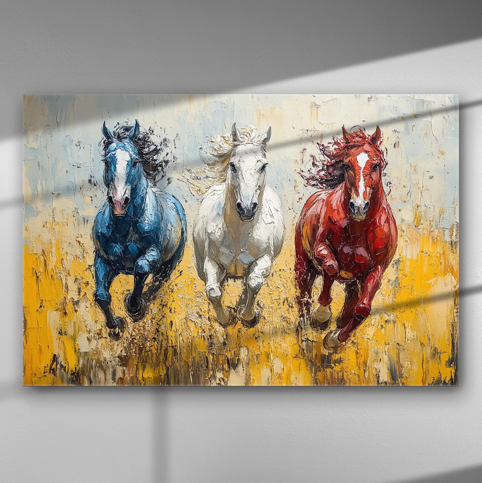 Canvas print of three galloping horses in blue, white, and red hues.