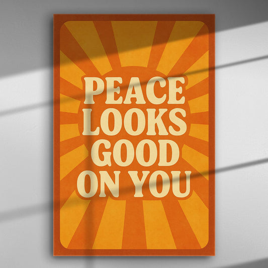 Canvas print with the message 'Peace Looks Good On You' on an orange sunburst background.