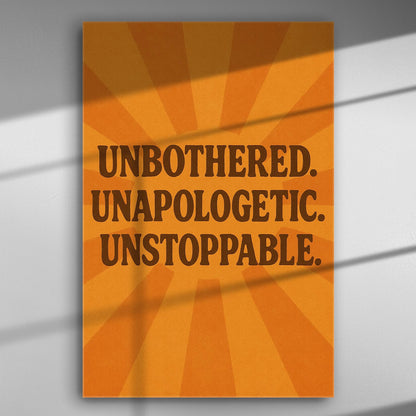 Orange canvas print with bold text 'Unbothered. Unapologetic. Unstoppable.' and radiant background