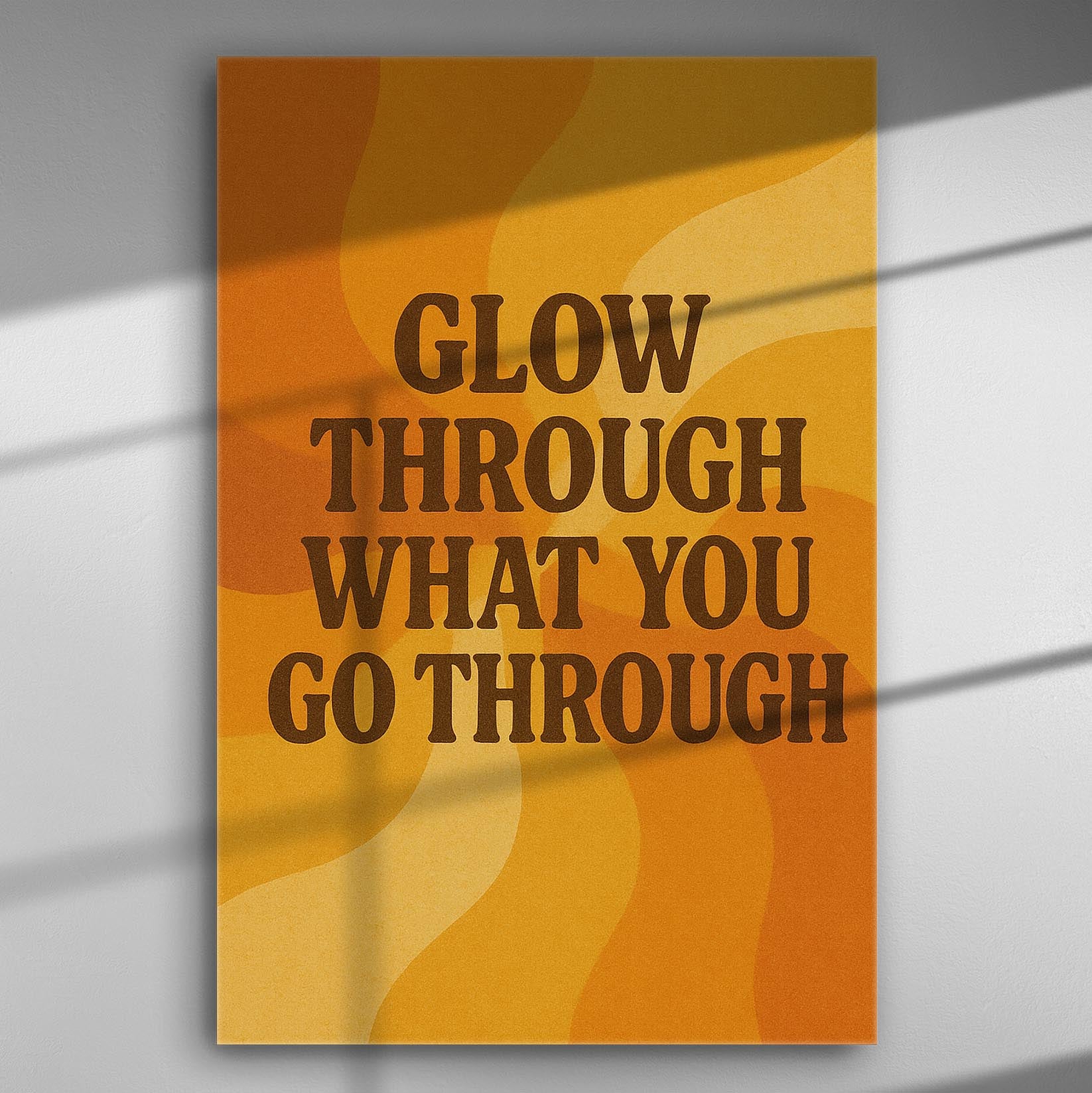 Inspirational canvas with the quote "Glow Through What You Go Through" in orange and yellow tones.