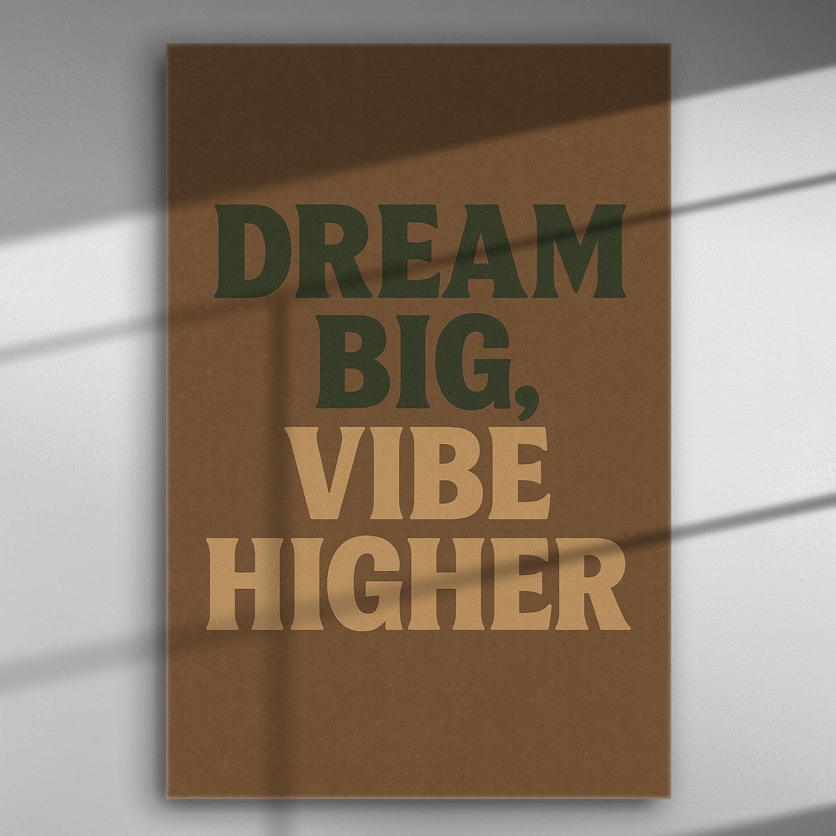 Motivational phrase "Dream Big, Vibe Higher" in bold typography on a brown background canvas.