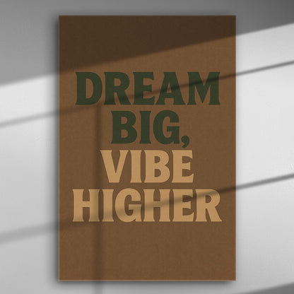 Motivational phrase "Dream Big, Vibe Higher" in bold typography on a brown background canvas.