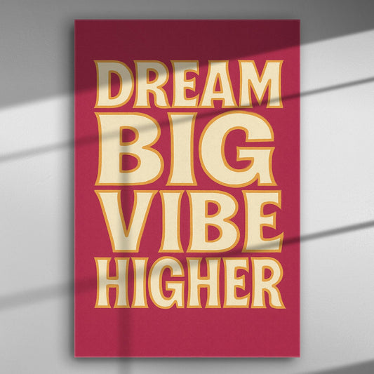 Canvas print with the motivational message 'Dream Big Vibe Higher' in bold letters on a red background.