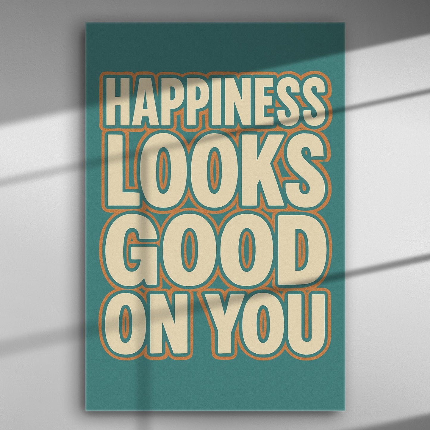 Canvas print with the phrase 'Happiness Looks Good On You' in bold letters on a colorful background.