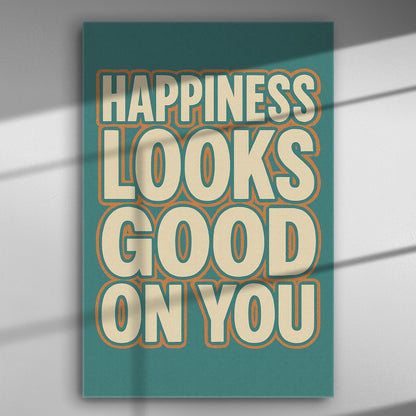 Canvas print with the phrase 'Happiness Looks Good On You' in bold letters on a colorful background.