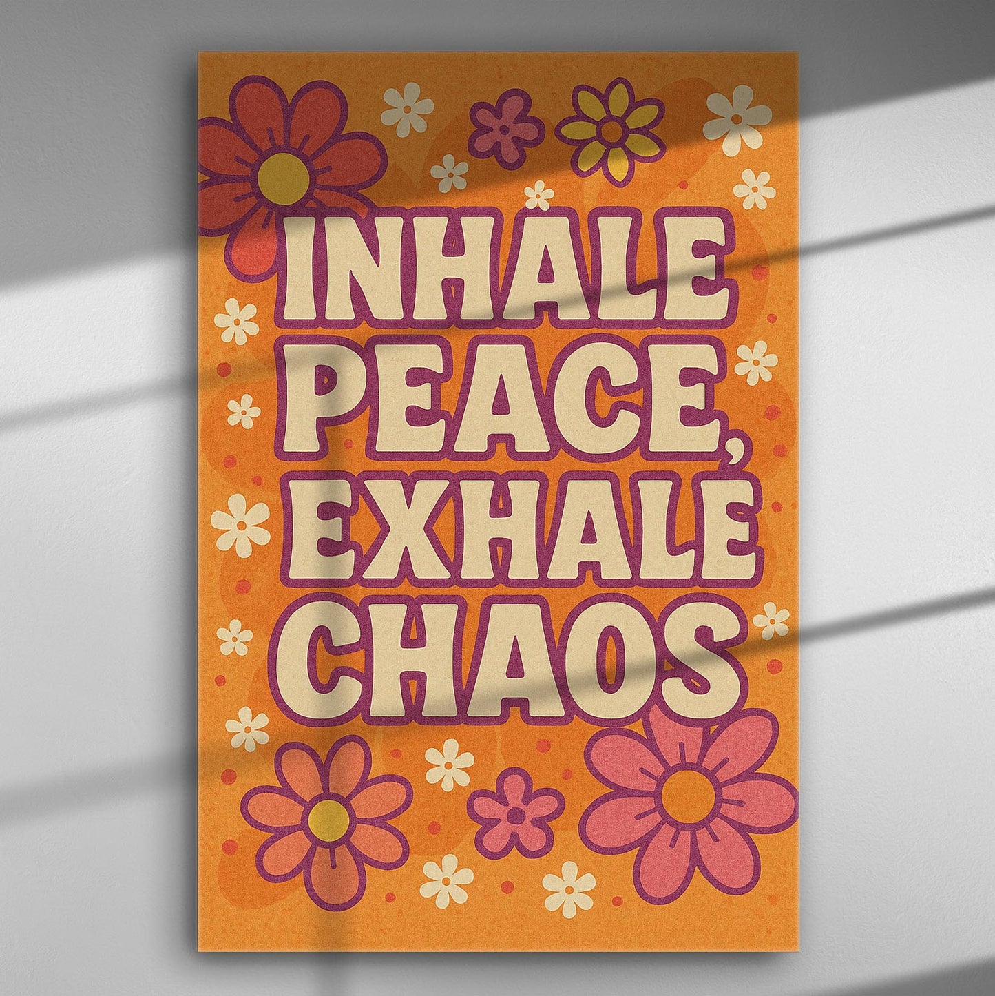 Canvas print with the message 'Inhale Peace, Exhale Chaos' surrounded by flowers in orange and purple hues.
