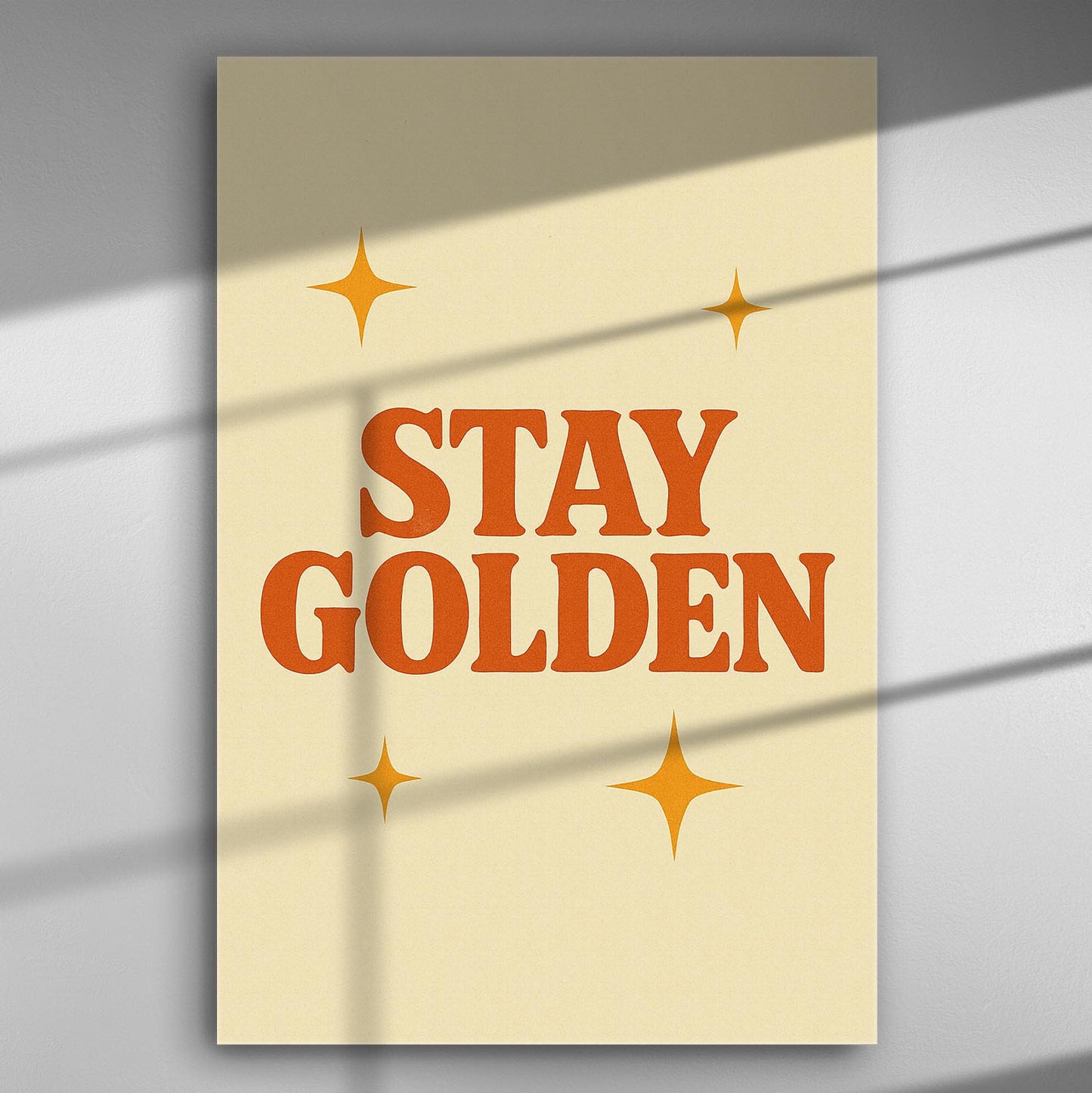 A canvas print with the phrase 'Stay Golden' and star designs on a light cream background.