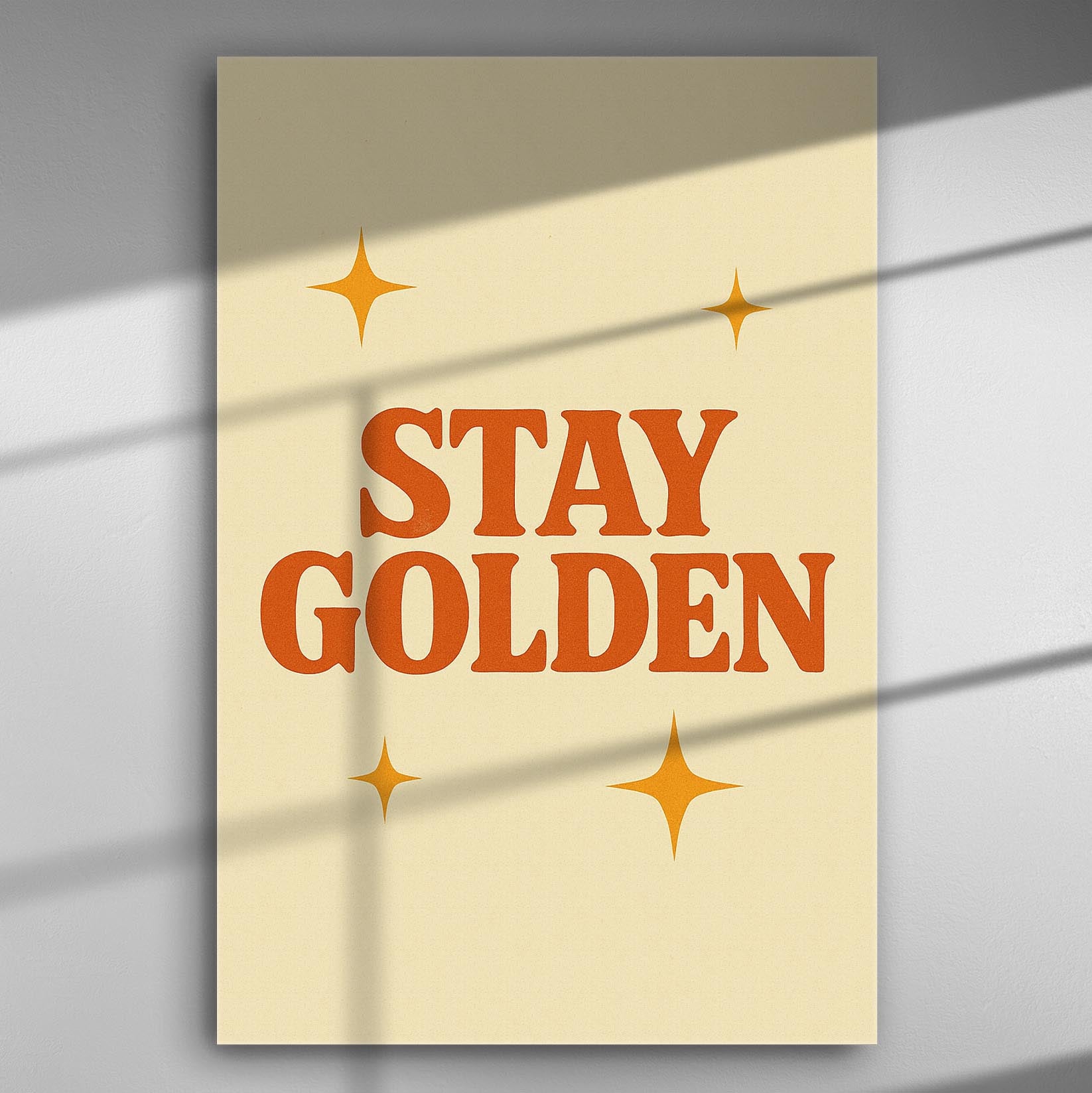 A canvas print with the phrase 'Stay Golden' and star designs on a light cream background.