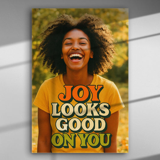 Smiling woman with text 'JOY LOOKS GOOD ON YOU' on canvas.