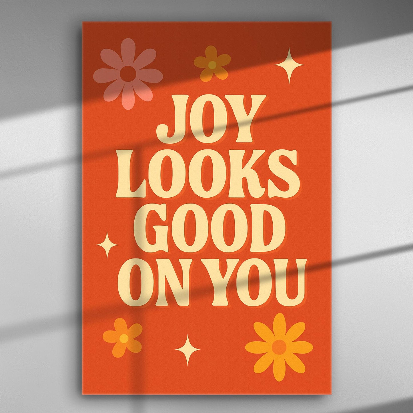 Canvas print with the text 'JOY LOOKS GOOD ON YOU' on an orange background with floral accents.