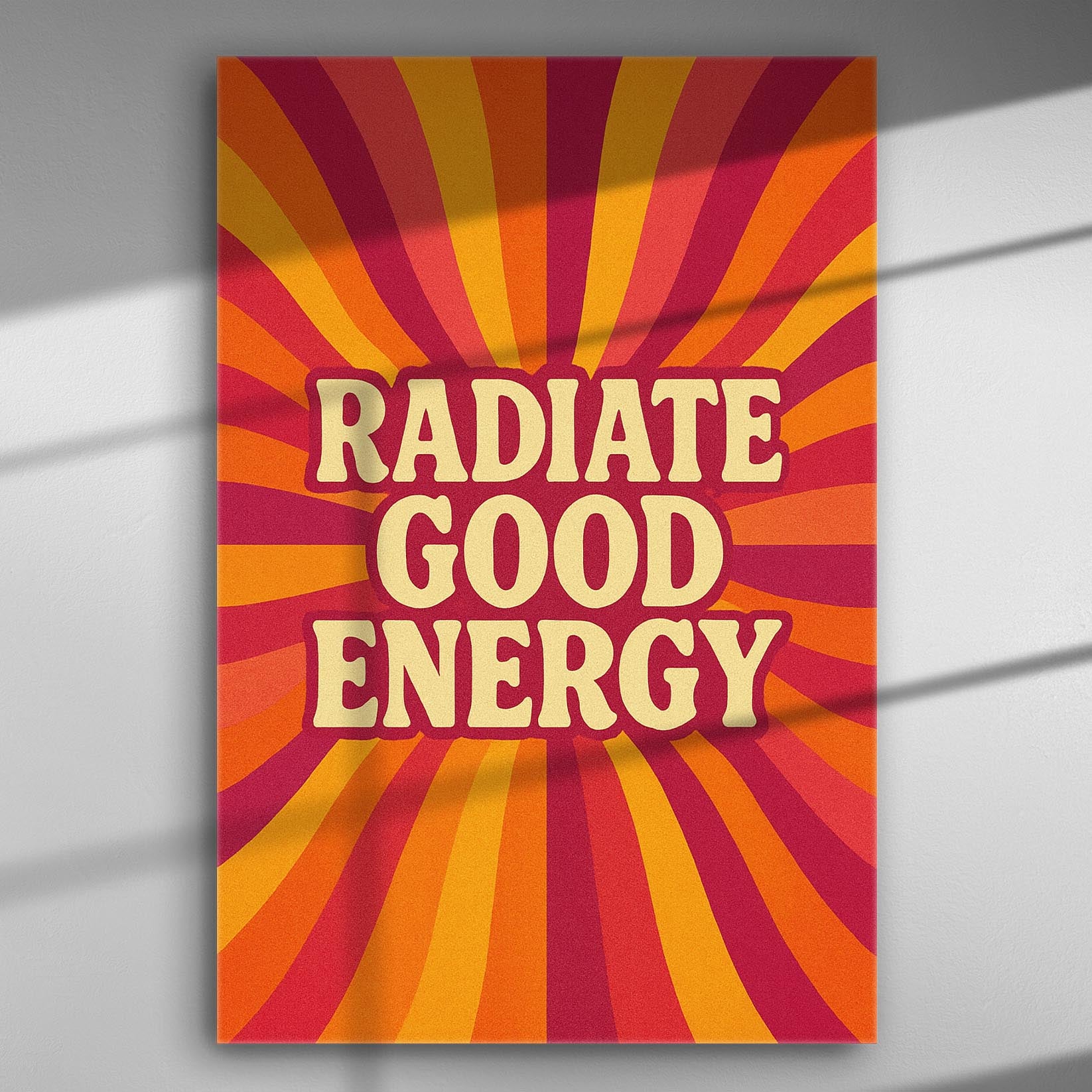 Abstract canvas print with the text 'Radiate Good Energy' on a vibrant orange and red background.