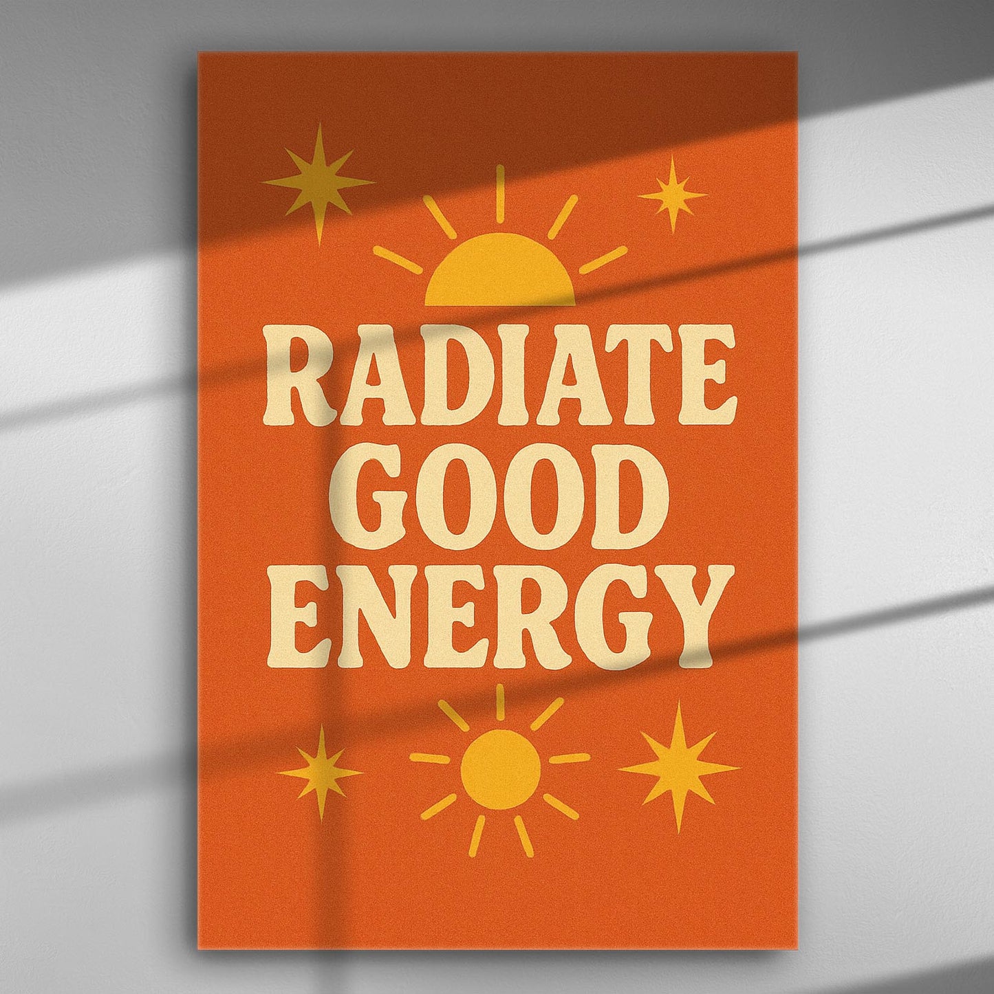 Orange canvas print with the text 'Radiate Good Energy' and sun symbols.