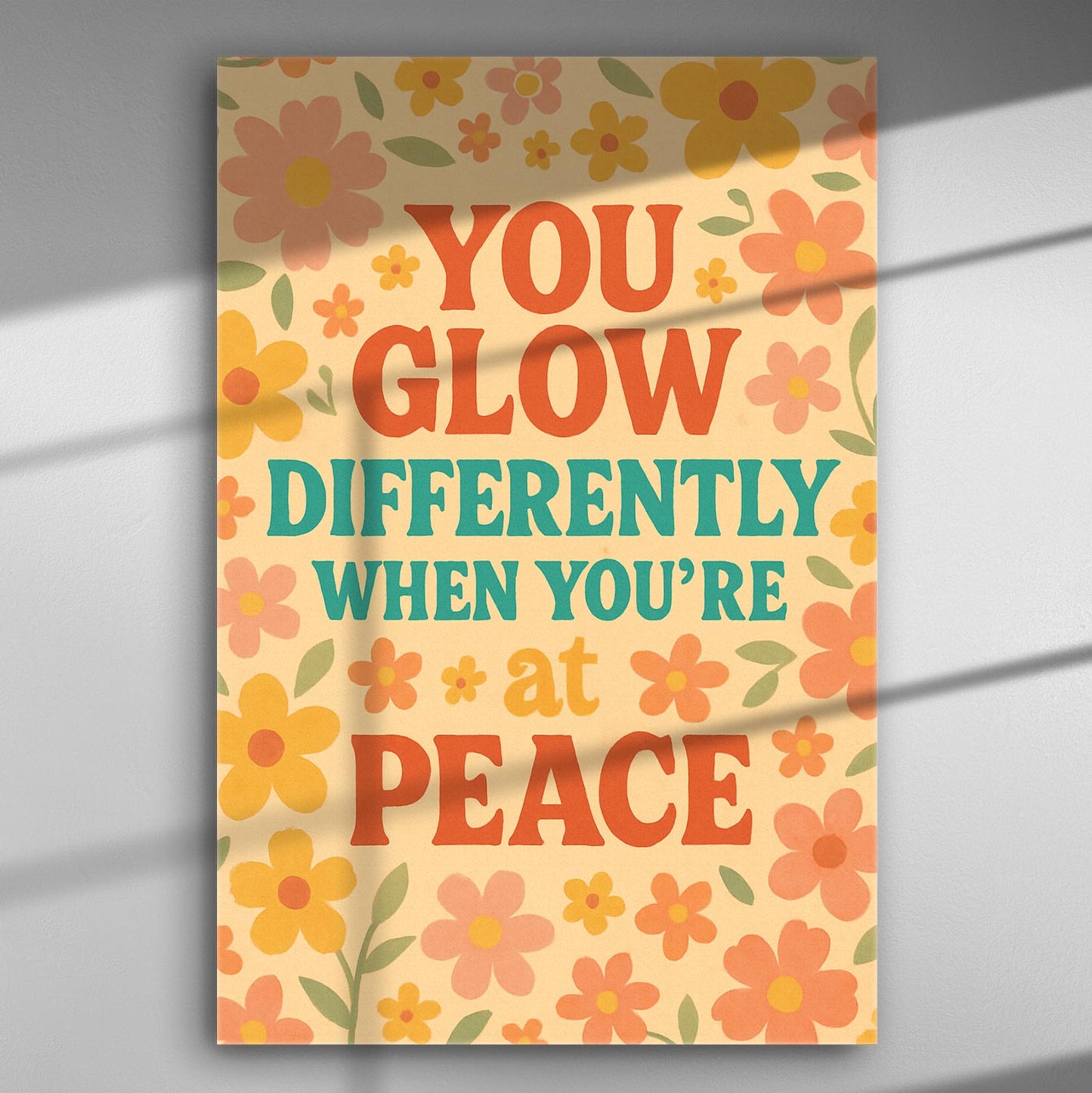 Colorful canvas print with the words 'You glow differently when you're at peace' surrounded by flowers.