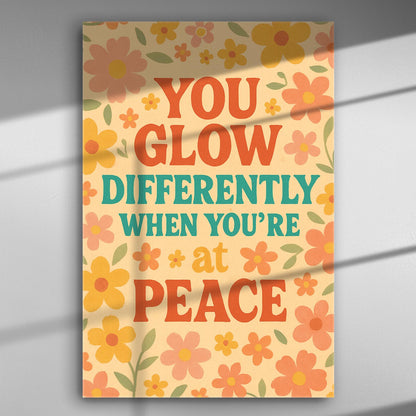 Colorful canvas print with the words 'You glow differently when you're at peace' surrounded by flowers.
