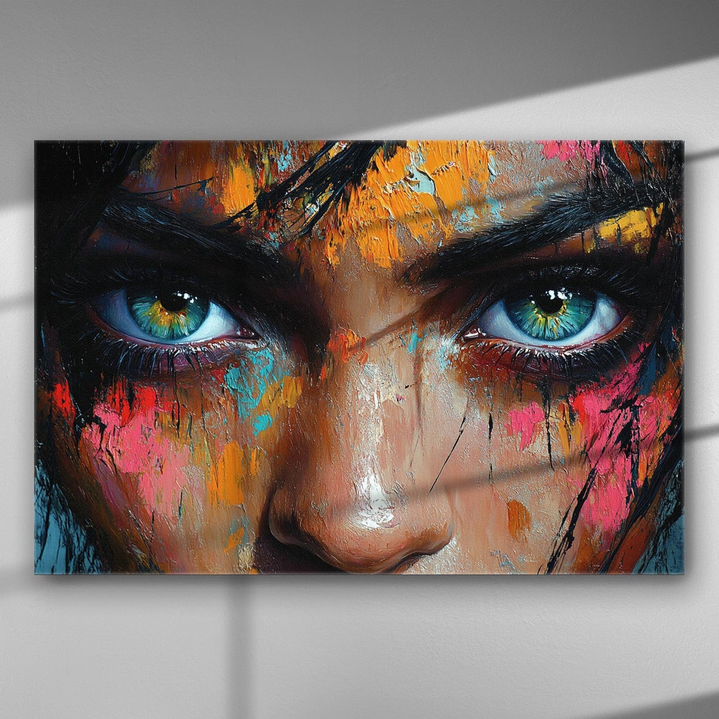 Close-up of abstract painting with expressive eyes and vibrant colors on canvas.