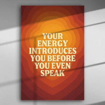 Canvas print with the phrase 'Your energy introduces you before you even speak' in warm orange and red tones.