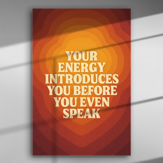 Canvas print with the phrase 'Your energy introduces you before you even speak' in warm orange and red tones.