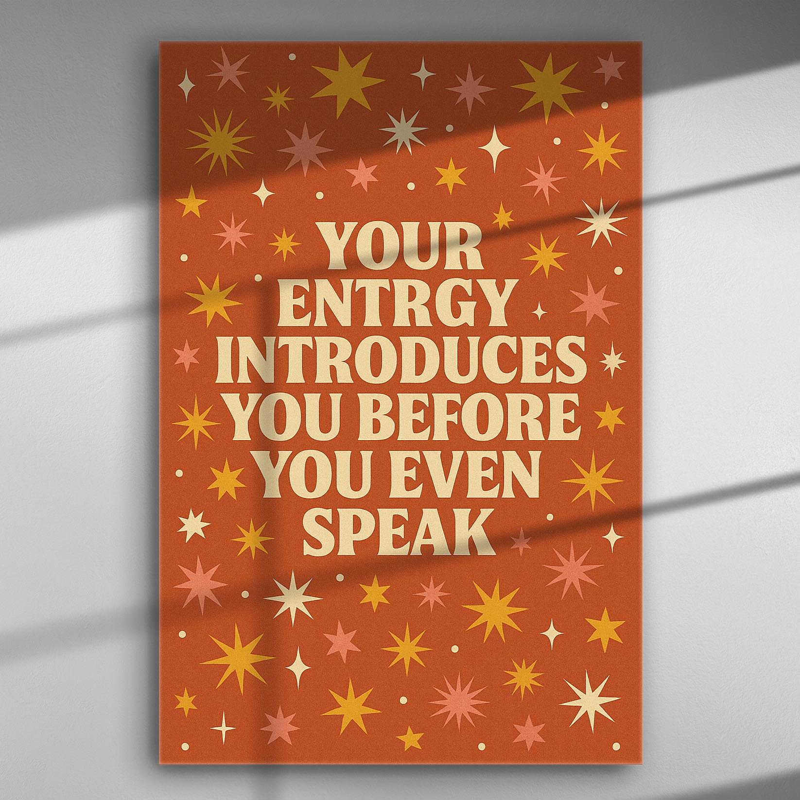 Canvas print with the quote 'Your energy introduces you before you even speak' on an orange background with stars.