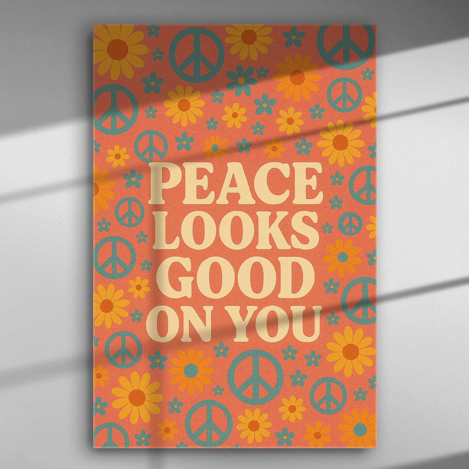 Canvas print with peace symbols and flowers on an orange background with the message 'Peace Looks Good On You'.
