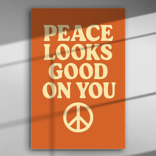 Canvas with the words 'Peace Looks Good On You' on an orange background with a peace symbol.