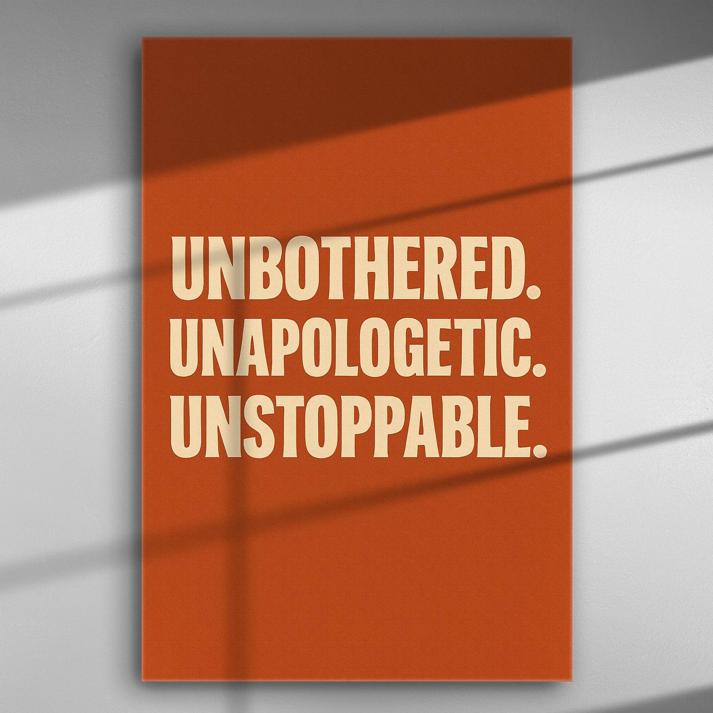 Canvas with motivational text reading 'Unbothered. Unapologetic. Unstoppable.' in bold letters on a red background.