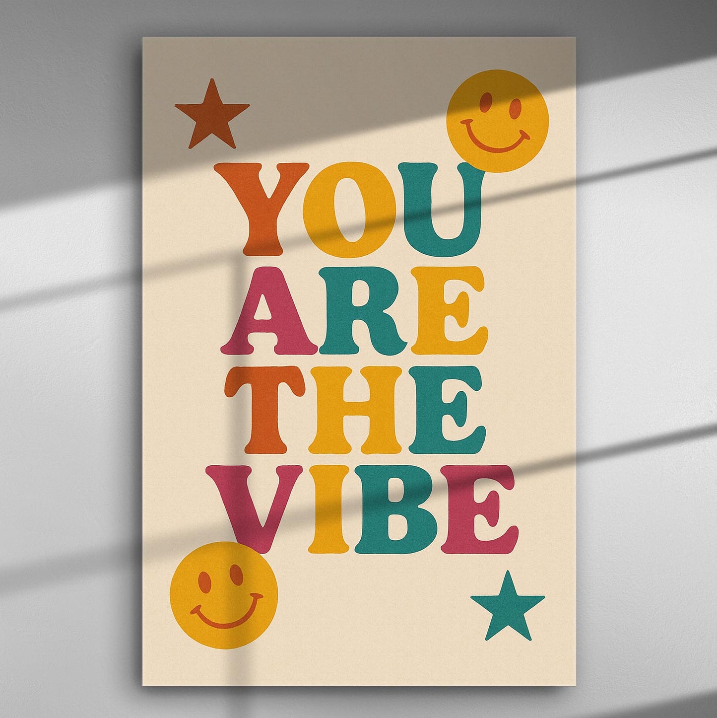 Colorful print with the words 'You Are The Vibe' accompanied by smiling faces and stars.