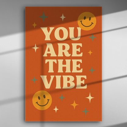 Canvas print with the text 'You Are The Vibe' on an orange background with smiley faces and stars.