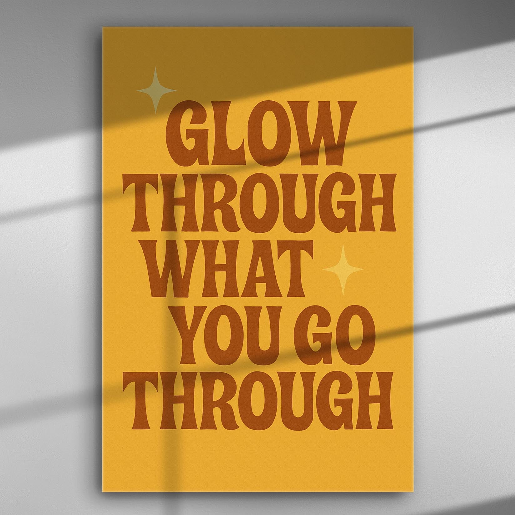Inspirational canvas print with the phrase 'Glow Through What You Go Through' in artistic lettering.