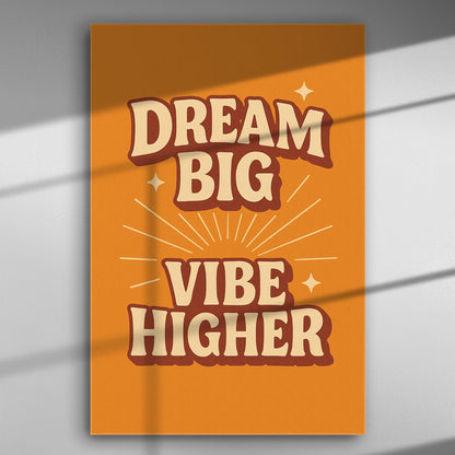 Motivational canvas print with the text 'Dream Big Vibe Higher' on an orange background.