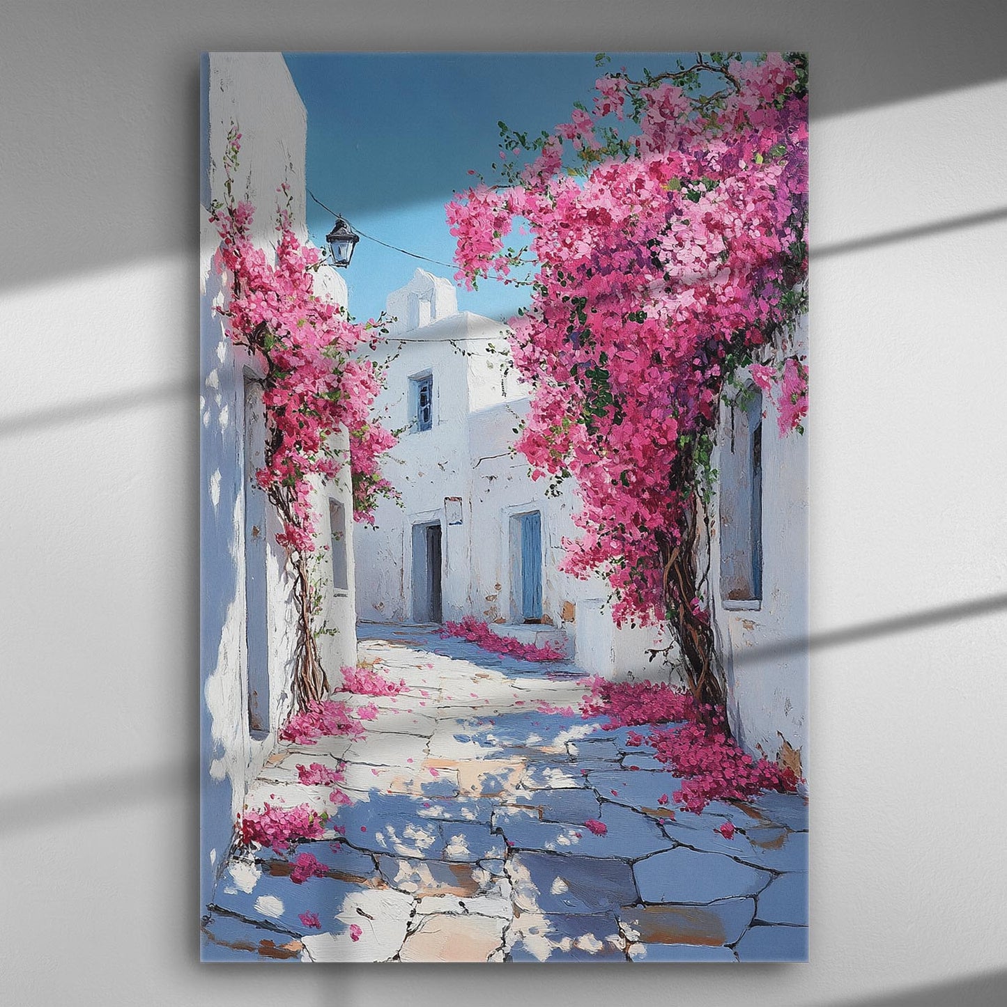 Canvas print depicting a picturesque alley with pink bougainvillea flowers and white-washed buildings.